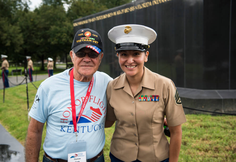 Veteran with active duty member at memorial